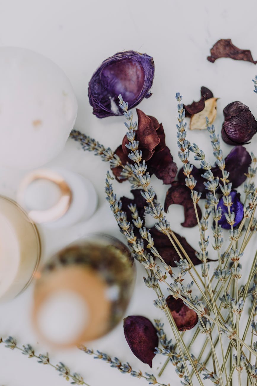 A collection of dried flowers on a marble table, and a few decorative bottles. Bolded white text reads "What's holding your character back?"